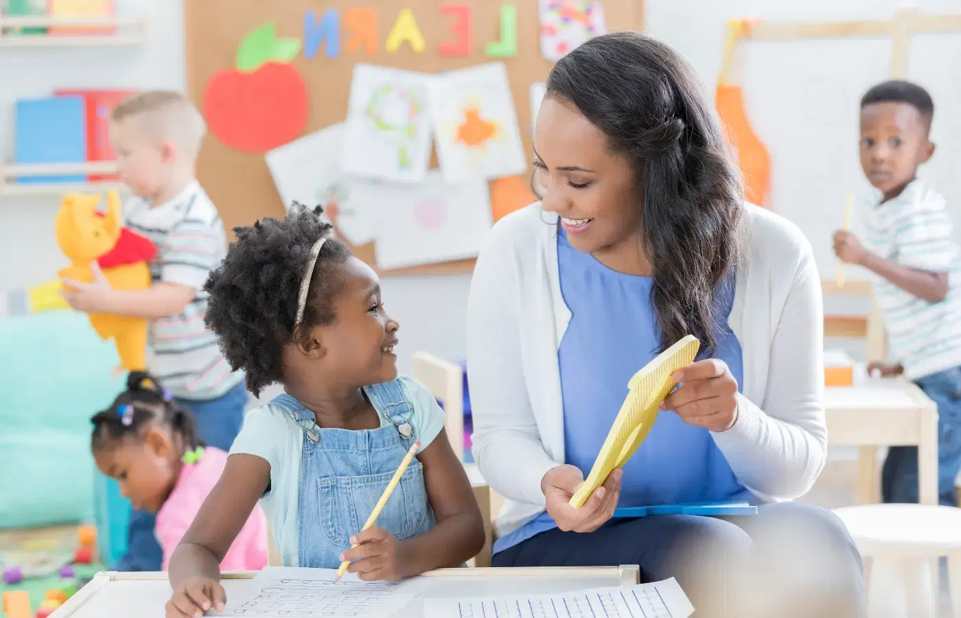 Woman and child learning the letter B