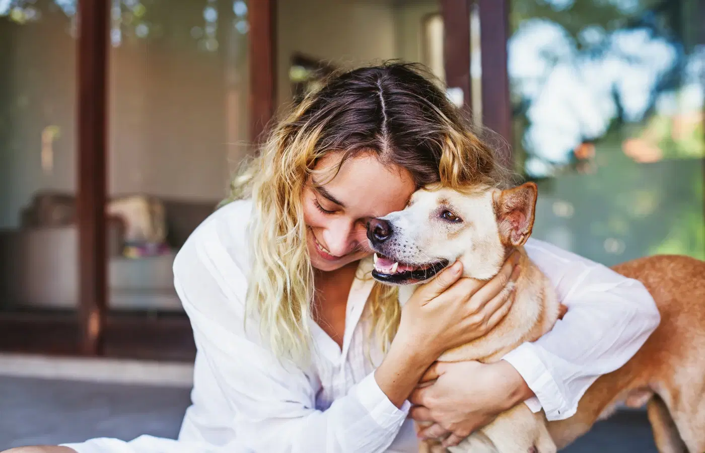 Woman hugging dog affectionately